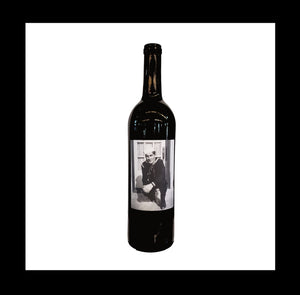 Bordeaux-style bottle with a label with a black-and-white photo of man in uniform kneeling on front porch step and looking at the camera.